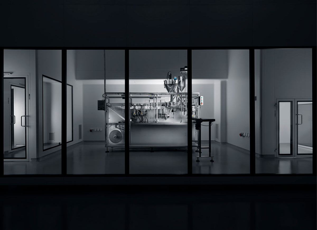 Neoderma Factory Filling Machine behind glass